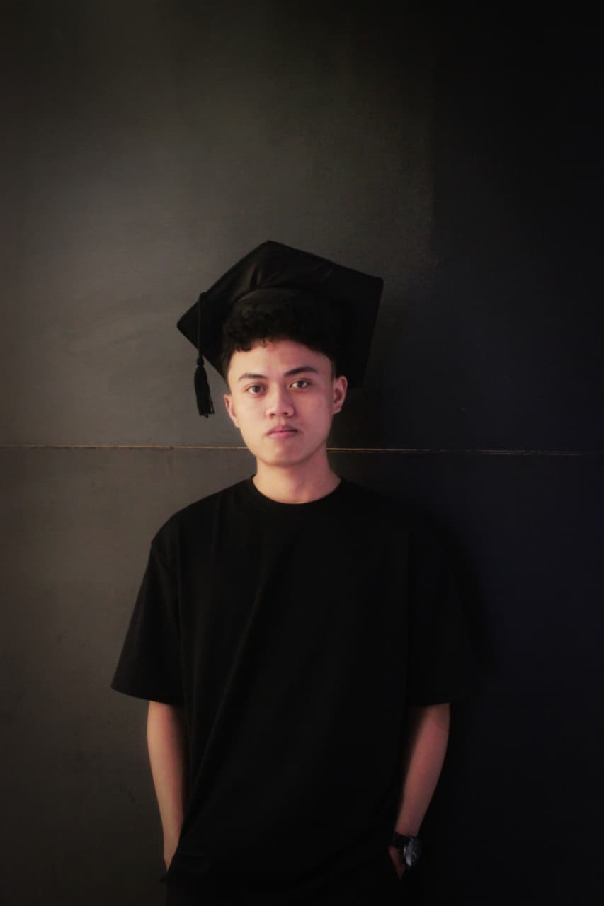 Muh. Fathir Anugrah R. wearing his graduation cap